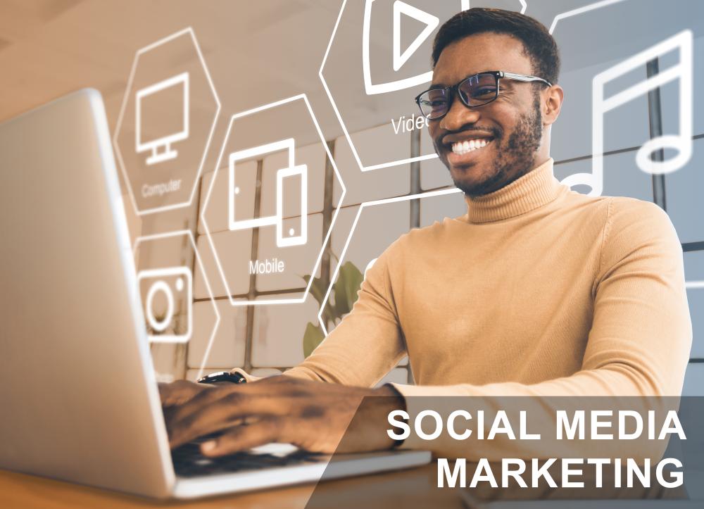 Happy African American influencer working on a laptop, engaging in social media marketing with icons representing digital platforms and multimedia.