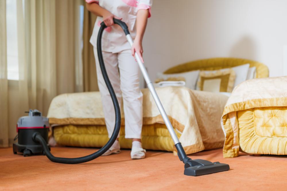 Professional maid vacuuming a Woodbury home during residential cleaning