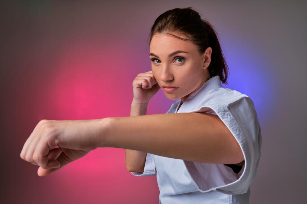 Woman practicing martial arts showing self-defense techniques